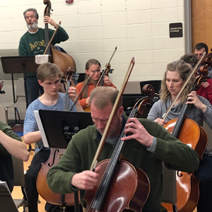 Students and KMS musicians play side-by-side.